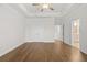 A spacious bedroom featuring hardwood floors and view to ensuite bath at 625 Skytop Dr, Cumming, GA 30040