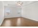 Large bedroom with a tray ceiling, ceiling fan, and natural light at 625 Skytop Dr, Cumming, GA 30040