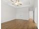 Large primary bedroom featuring hardwood floors, tray ceiling, and attached bathroom at 625 Skytop Dr, Cumming, GA 30040