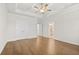 Primary bedroom features hardwood floors, tray ceiling, and attached bathroom at 625 Skytop Dr, Cumming, GA 30040