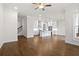 Open-concept living area with hardwood floors and a view of the modern, eat-in kitchen at 625 Skytop Dr, Cumming, GA 30040