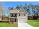 Charming two-story home featuring a 2-car garage, manicured lawn, and a mix of brick and vinyl siding at 108 Wheelers Dr, Dallas, GA 30157