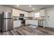 Well-equipped kitchen boasting stainless steel appliances, white cabinetry, granite countertops, and hardwood flooring at 108 Wheelers Dr, Dallas, GA 30157