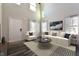 Bright living room with a soaring ceiling, modern furniture, and large windows dressed with elegant curtains at 108 Wheelers Dr, Dallas, GA 30157