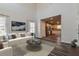 Sunlit living room with hardwood floors, a white couch, and an open layout connected to the adjacent kitchen at 108 Wheelers Dr, Dallas, GA 30157