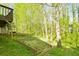 Backyard with grass, retaining wall and trees at 144 Grayland Hills Ct, Lawrenceville, GA 30046