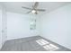 Sunlit bedroom with a ceiling fan and plush carpeting at 144 Grayland Hills Ct, Lawrenceville, GA 30046