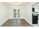 Elegant dining room with modern light fixture and French doors leading outside at 144 Grayland Hills Ct, Lawrenceville, GA 30046