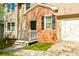Close-up of the front porch featuring a brick facade and a black front door at 144 Grayland Hills Ct, Lawrenceville, GA 30046