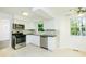 Well-lit kitchen featuring stainless steel appliances, white cabinets, and a granite countertop at 144 Grayland Hills Ct, Lawrenceville, GA 30046