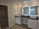 Modern bathroom featuring double vanity with vessel sinks, granite counters, and backlit mirrors at 1636 Fuma Leaf Way, Mcdonough, GA 30253