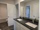 Bathroom showcasing granite countertops with dual sinks, white cabinetry, and a shower at 1636 Fuma Leaf Way, Mcdonough, GA 30253