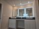 Modern bathroom vanity with illuminated mirrors and dual sinks offering contemporary style at 1636 Fuma Leaf Way, Mcdonough, GA 30253