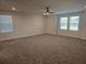 Spacious bedroom with a ceiling fan, carpet, and ample natural light from multiple windows at 1636 Fuma Leaf Way, Mcdonough, GA 30253
