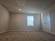 Spacious bedroom with a window and a closet, neutral walls and carpet, and minimal natural light at 1636 Fuma Leaf Way, Mcdonough, GA 30253