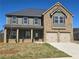 Charming two-story home with a brick and siding facade, complemented by a two-car garage and well-manicured lawn at 1636 Fuma Leaf Way, Mcdonough, GA 30253