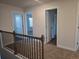 Upstairs hallway with carpet, doors to bedrooms, and views into the bedrooms at 1636 Fuma Leaf Way, Mcdonough, GA 30253