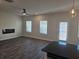 Spacious living area features a modern fireplace, a ceiling fan, a doorway to the outside and natural light at 1636 Fuma Leaf Way, Mcdonough, GA 30253