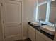 Elegant main bathroom featuring double vessel sinks, granite countertops, and well-lit, modern mirrors at 1636 Fuma Leaf Way, Mcdonough, GA 30253