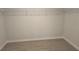 Empty walk-in closet with neutral walls, and a built in rack for ample storage space at 1636 Fuma Leaf Way, Mcdonough, GA 30253