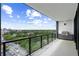 Wide balcony area with a grill, glass railing, and overlooking a picturesque green cityscape at 2425 Peachtree Ne Rd # 1409, Atlanta, GA 30305