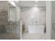 Contemporary bathroom features a glass-enclosed shower and a freestanding soaking tub at 2425 Peachtree Ne Rd # 1409, Atlanta, GA 30305