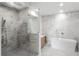 Contemporary bathroom featuring marble tile, a glass-enclosed shower, and a freestanding tub at 2425 Peachtree Ne Rd # 1409, Atlanta, GA 30305