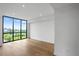Light-filled bedroom with hardwood floors and a large window offering city and treetop views at 2425 Peachtree Ne Rd # 1409, Atlanta, GA 30305