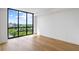 Bedroom with large window and wood floors, offering city views at 2425 Peachtree Ne Rd # 1409, Atlanta, GA 30305