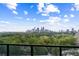 Expansive city view overlooking lush greenery with blue skies and scattered clouds at 2425 Peachtree Ne Rd # 1409, Atlanta, GA 30305