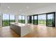 Modern kitchen with island, hardwood floors, floor to ceiling windows, and a scenic city view at 2425 Peachtree Ne Rd # 1409, Atlanta, GA 30305