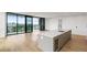 Bright kitchen featuring an island, hardwood floors, and floor-to-ceiling windows with a city view at 2425 Peachtree Ne Rd # 1409, Atlanta, GA 30305