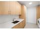 Bright laundry room featuring modern appliances, quartz counters, and ample cabinet space at 2425 Peachtree Ne Rd # 1409, Atlanta, GA 30305