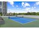 Full tennis court on a rooftop featuring greenery and a view of a modern high rise at 2425 Peachtree Ne Rd # 1409, Atlanta, GA 30305