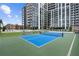 Full tennis court on a rooftop with greenery, lounge chairs, and views of the surrounding landscape at 2425 Peachtree Ne Rd # 1409, Atlanta, GA 30305