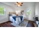 Nicely staged bedroom with a queen bed, gray rug, and two windows at 80 E Howard St, Kingston, GA 30145