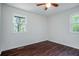 Cozy bedroom with two windows, hardwood floors and white walls at 80 E Howard St, Kingston, GA 30145