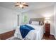 Bedroom view with a queen bed, neutral decor, and two windows at 80 E Howard St, Kingston, GA 30145