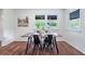 Bright dining area featuring hardwood floors, a modern table, and windows providing natural light and a pleasant view at 80 E Howard St, Kingston, GA 30145