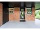 A covered entrance featuring a modern glass door and a brick facade, creating an inviting arrival at 80 E Howard St, Kingston, GA 30145