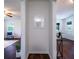 Hallway displaying decorative wall paneling and hardwood floors, leading to living and dining spaces at 80 E Howard St, Kingston, GA 30145