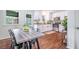 Charming kitchen featuring white cabinetry, stainless steel appliances, and a spacious dining area with modern table at 80 E Howard St, Kingston, GA 30145
