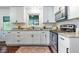 Bright kitchen features white cabinets, granite countertops, stainless steel appliances, and hardwood floors at 80 E Howard St, Kingston, GA 30145
