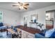 Cozy living room featuring hardwood floors, a ceiling fan, and plenty of natural light from the windows at 80 E Howard St, Kingston, GA 30145