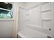 Shower tub with white walls and shelving at 80 E Howard St, Kingston, GA 30145