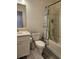 Neat bathroom features a toilet, sink with a vanity, and a shower-tub with a stylish curtain at 1297 Ascot Ter, Atlanta, GA 30329