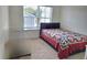 Cozy bedroom featuring a comfortable bed with a colorful quilt and a bright window at 1297 Ascot Ter, Atlanta, GA 30329