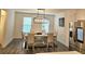 Dining room boasts luxury vinyl floors, modern lighting, and stainless refrigerator at 1297 Ascot Ter, Atlanta, GA 30329