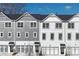 Beautiful townhome showcases multi-tone color, garage, and covered front porch at 1297 Ascot Ter, Atlanta, GA 30329