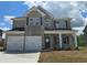 Charming two-story home with brick facade, black shutters and a two-car garage at 1613 Fuma Leaf Way, Mcdonough, GA 30253
